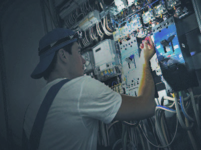 Industrial worker working on a high voltage switchboard
