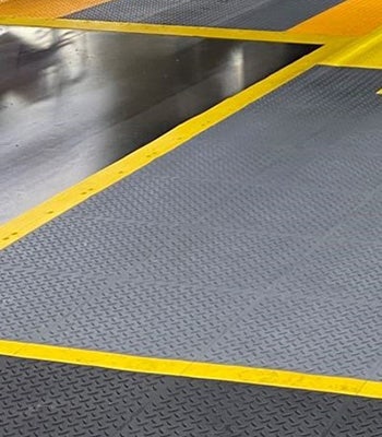 Wearwell's customizable ErgoDeck matting installed to designate different areas of the workspace.